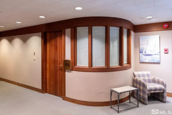 a very nice looking room with a large window and furniture