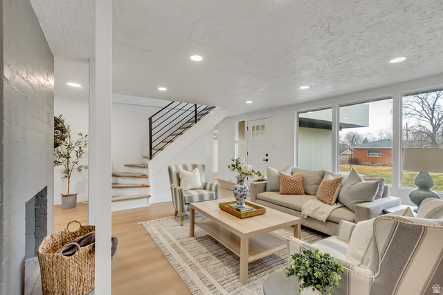 337 West 2900th Street South Bountiful, UT 84010 - Photo 2 of 35 Living room with light wood-style flooring, recessed lighting, and a textured ceiling