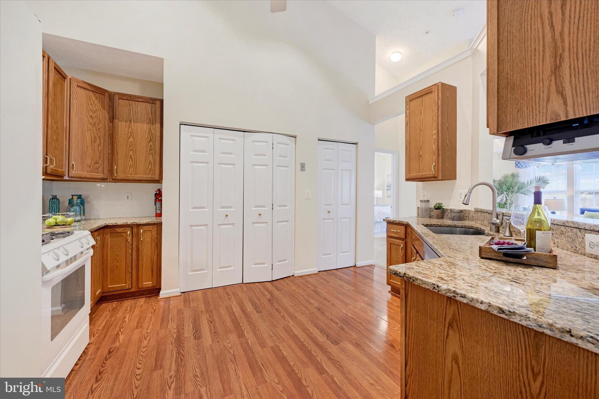 9606 Haven Farm Road, Unit 9606M Perry Hall, MD 21128 - Photo 16 of 49 a kitchen with granite countertop wooden floors and granite counter tops
