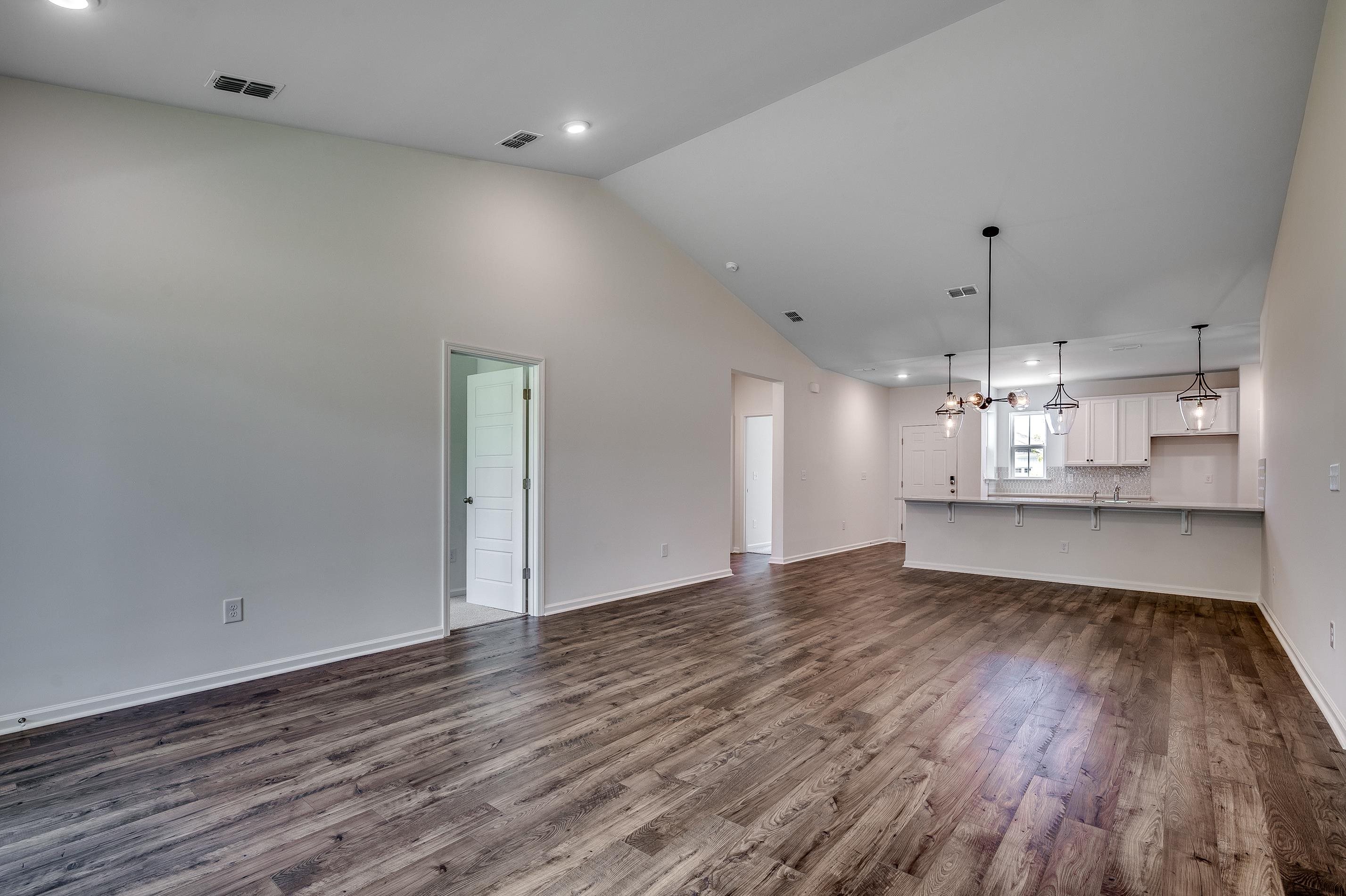 133 Buckingham Drive Loris, SC 29569 - Photo 13 of 17 Unfurnished living room featuring recessed lighting, dark wood-style floors, a chandelier, and high vaulted ceiling