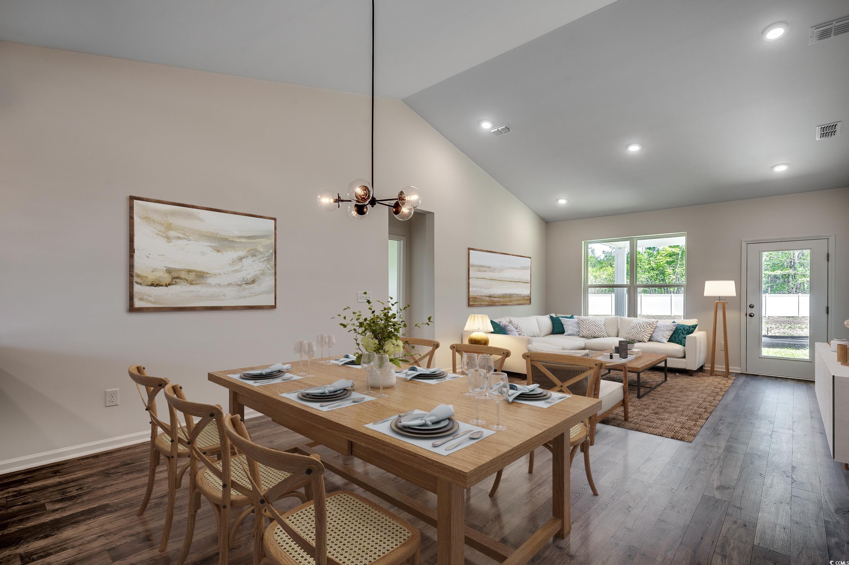 133 Buckingham Drive Loris, SC 29569 - Photo 3 of 17 Dining space with a chandelier, high vaulted ceiling, dark wood-style floors, and recessed lighting