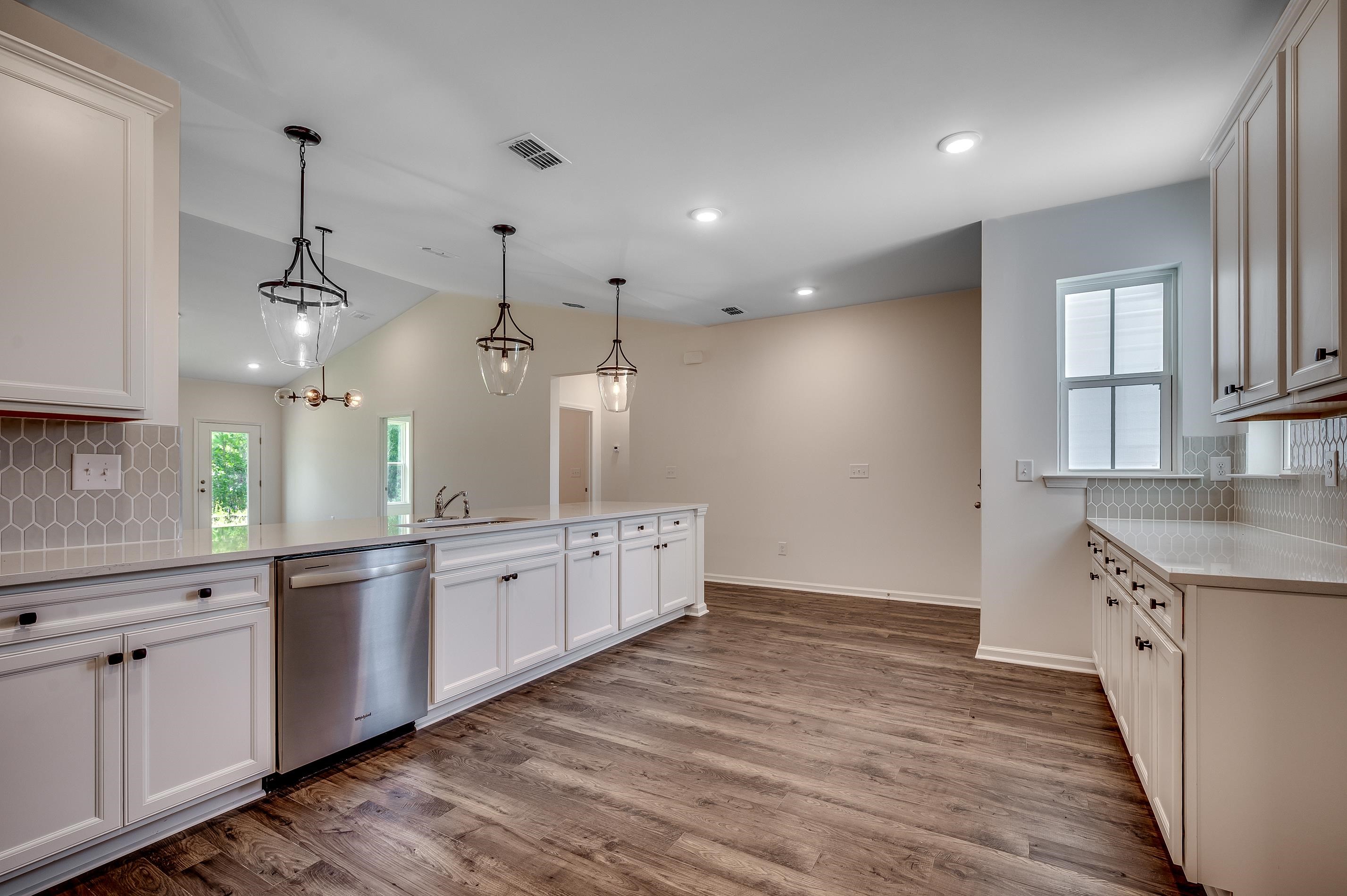 133 Buckingham Drive Loris, SC 29569 - Photo 9 of 17 Kitchen with tasteful backsplash, dishwasher, hanging light fixtures, white cabinetry, and recessed lighting