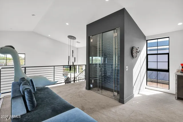 a living room with furniture a flat screen tv and a large window