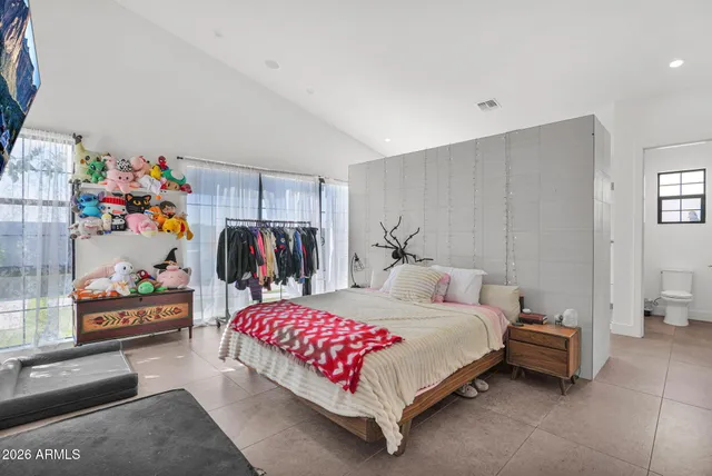 a bedroom with a bed and a window