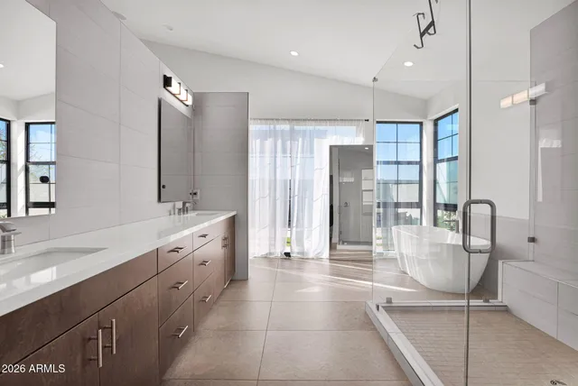 a large bathroom with a glass door shower and sink