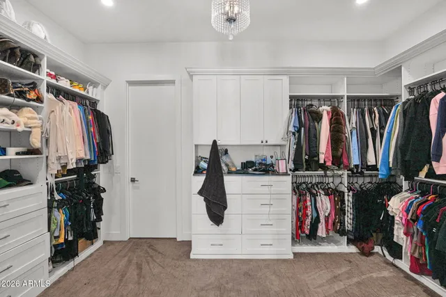 a view of walk in closet with clothes