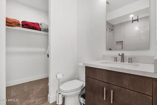 a bathroom with a sink vanity mirror and toilet