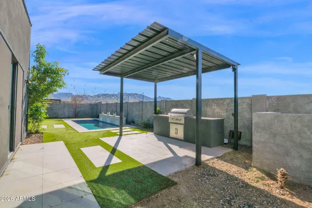 a view of a field with a tree in the background