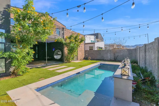 a view of a backyard with a patio and a yard