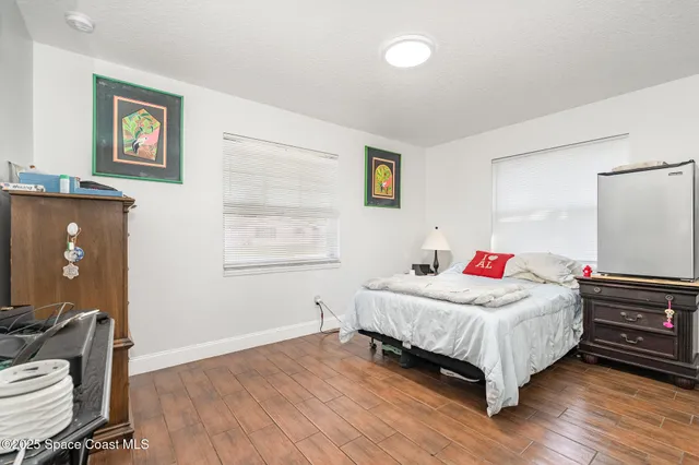 a bedroom with a bed table and a window