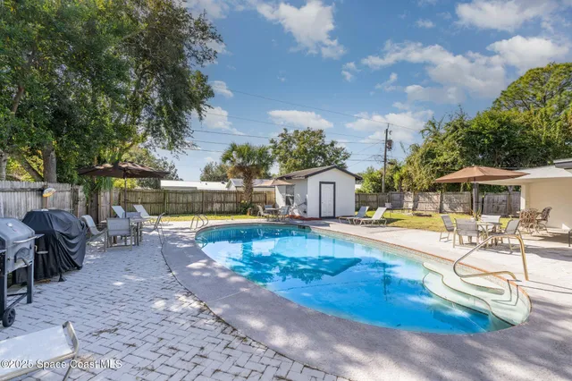 an outdoor space with swimming pool and furniture