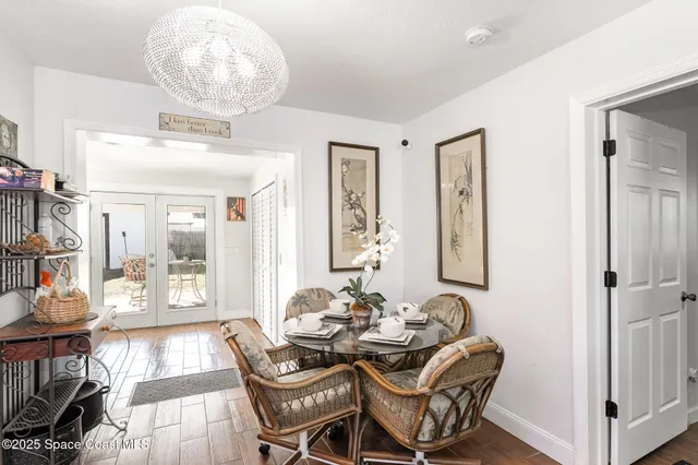 a dining room with furniture and chandelier
