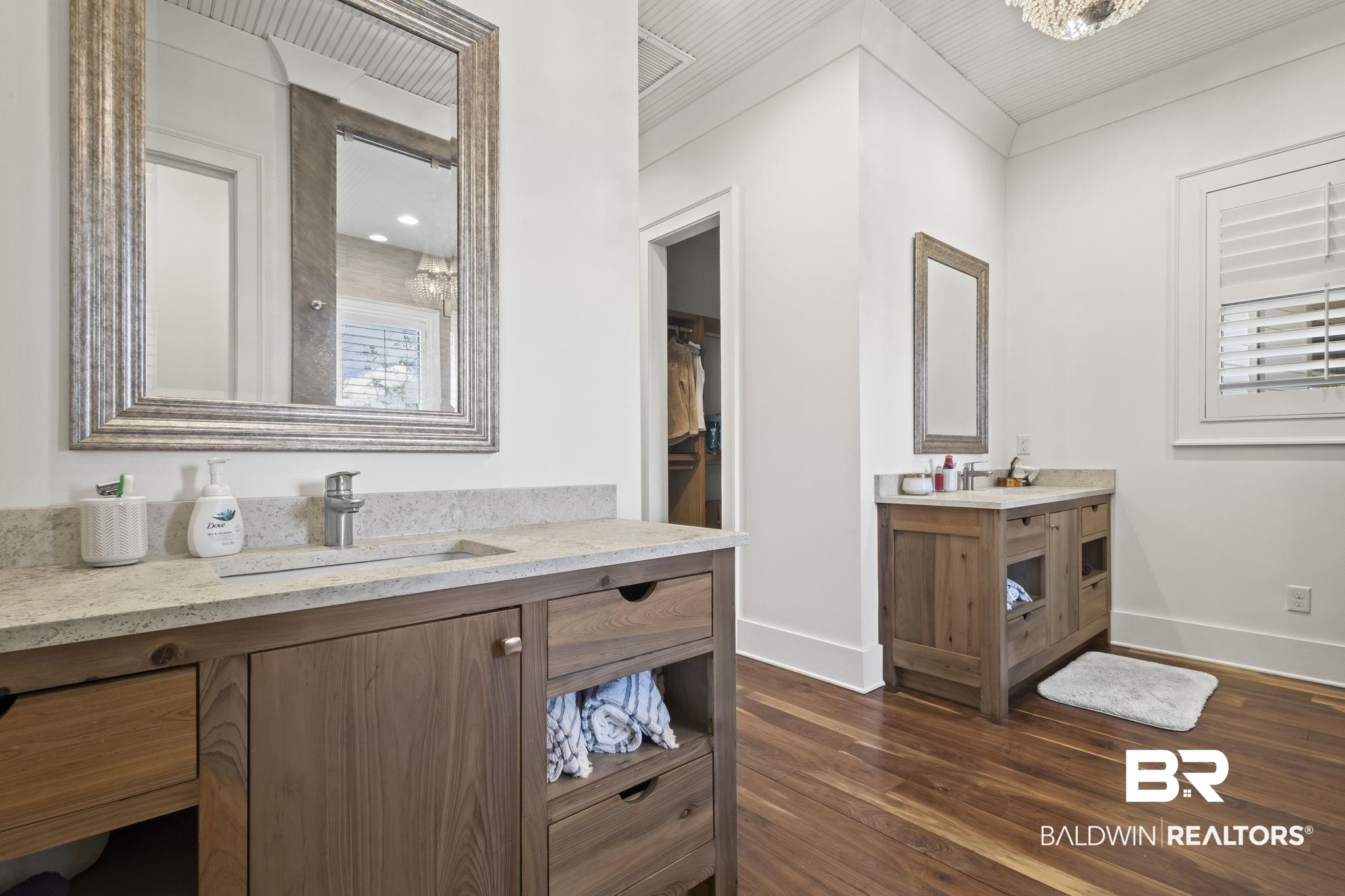 15020 River Road Fairhope, AL 36532 - Photo 16 of 59 Bathroom with an inviting chandelier, wood-type flooring, and vanity