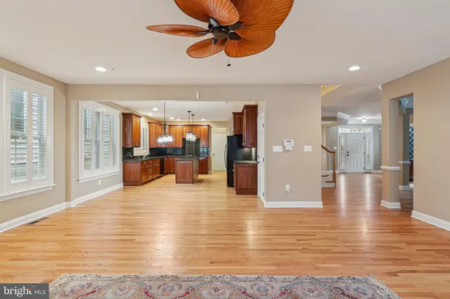 a view of a room with wooden floor staircase and a chandelier