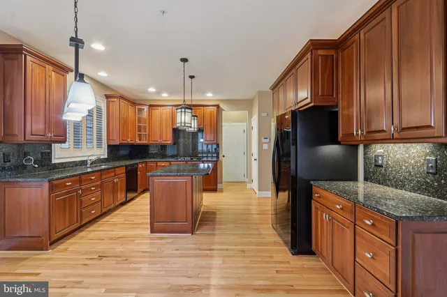 a view of empty room with wooden floor and window