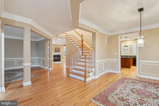 a view of a livingroom with wooden floor and a fireplace