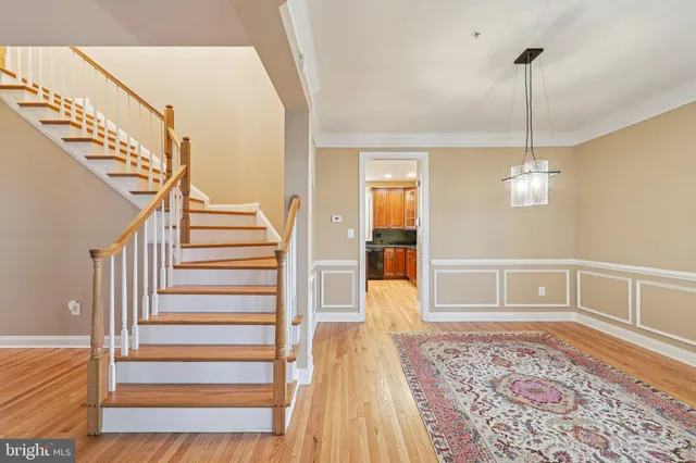a kitchen with stainless steel appliances granite countertop a refrigerator a sink and wooden cabinets