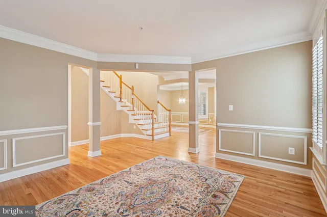 a kitchen with stainless steel appliances granite countertop a refrigerator a stove and a sink with wooden floor