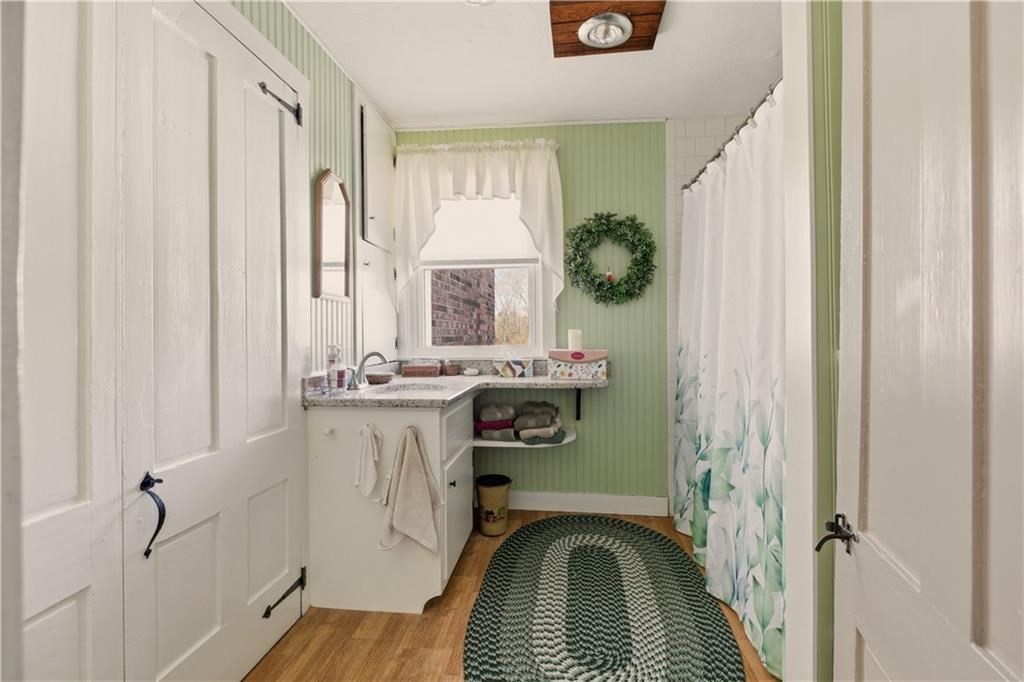 13 Shippee Schoolhouse Road Foster, RI 02825 - Photo 11 of 42 a bathroom with a sink a mirror and a window