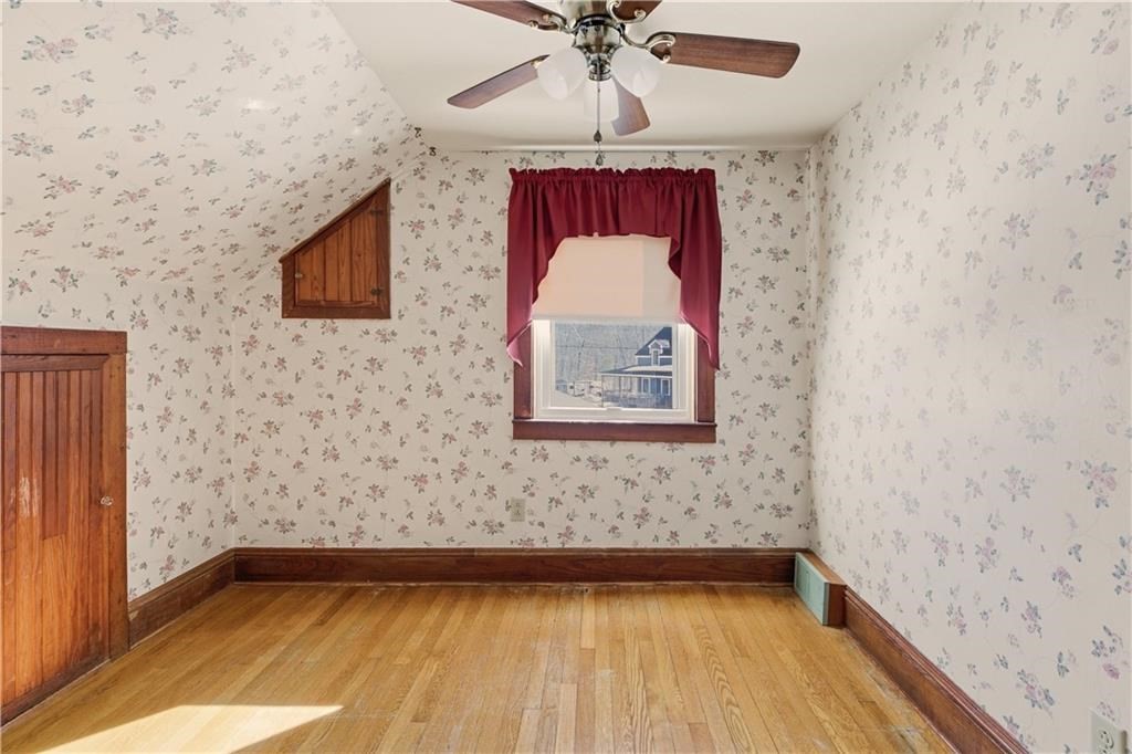 13 Shippee Schoolhouse Road Foster, RI 02825 - Photo 27 of 42 a view of a hallway with wooden floor and chandelier