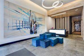 222 West Avenue, Unit 2207 Austin, TX 78701 - Photo 18 of 30 Modern lobby featuring large format tile flooring and an abstract wall mural