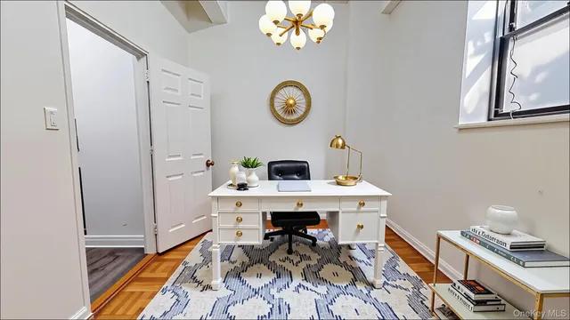 a workspace with furniture and chandelier