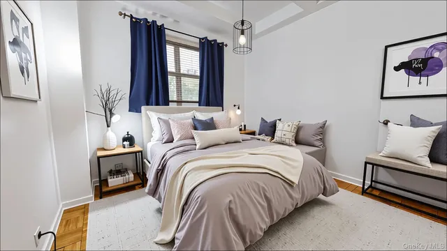 a bedroom with a bed and a painting on the wall