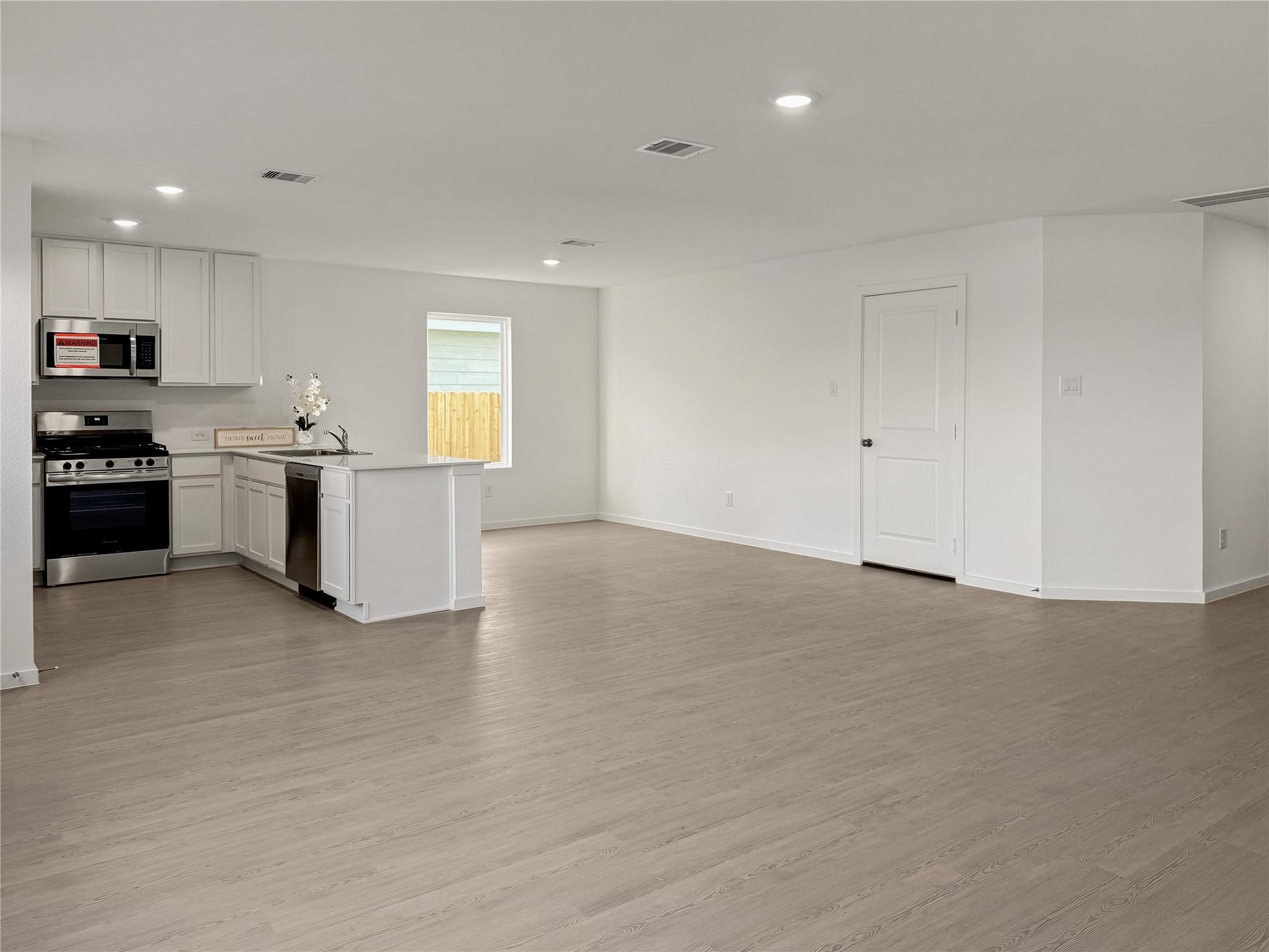 12430 Wild Strawberry Road Houston, TX 77038 - Photo 5 of 34 Spacious gathering area, perfect for comfortable family time and entertaining guests.