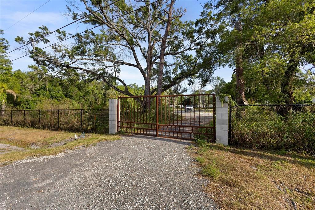 a view of a field with wooden fence