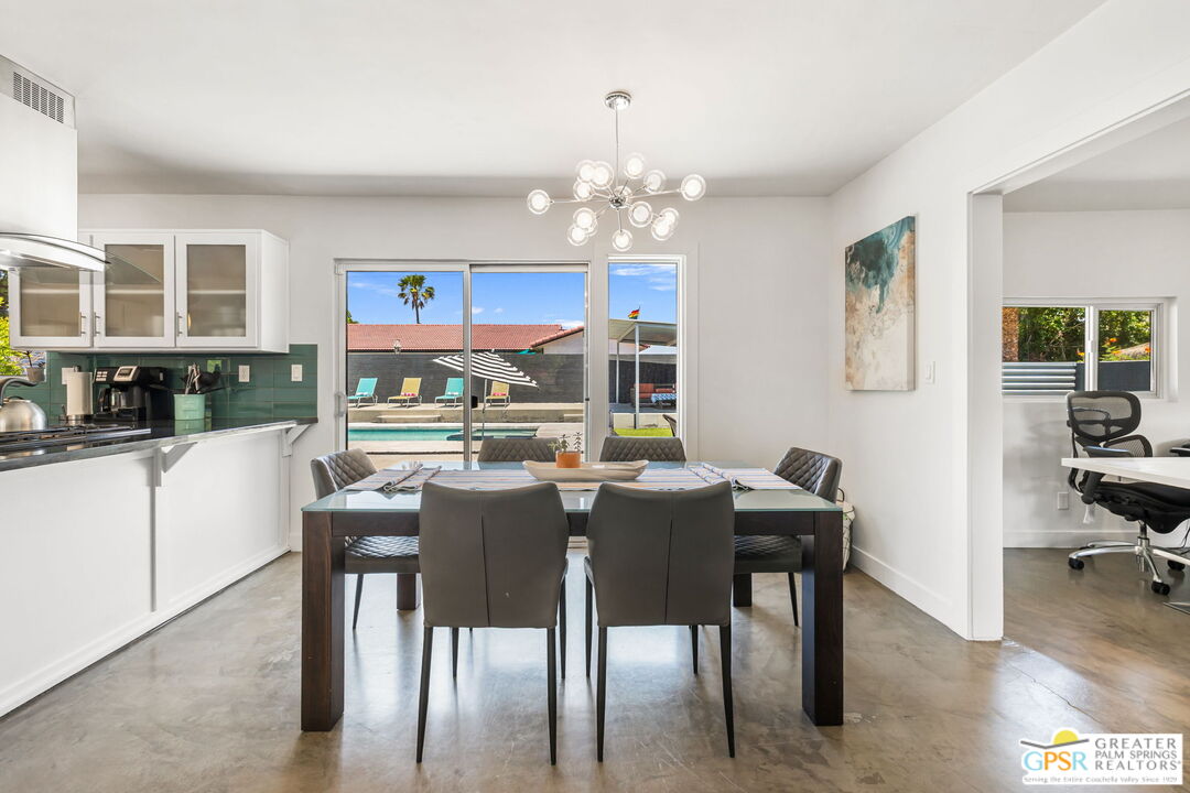490 East Molino Road Palm Springs, CA 92262 - Photo 19 of 47 a view of a dining room with furniture and a chandelier