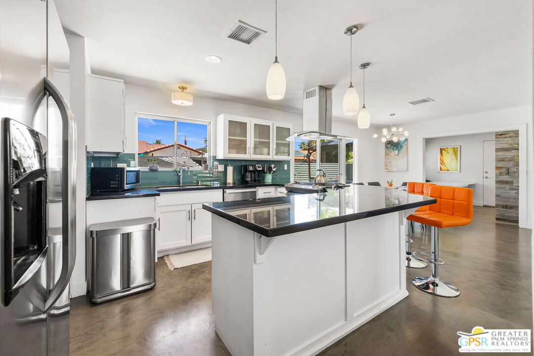 490 East Molino Road Palm Springs, CA 92262 - Photo 22 of 47 a kitchen with stainless steel appliances granite countertop a sink a stove and a refrigerator