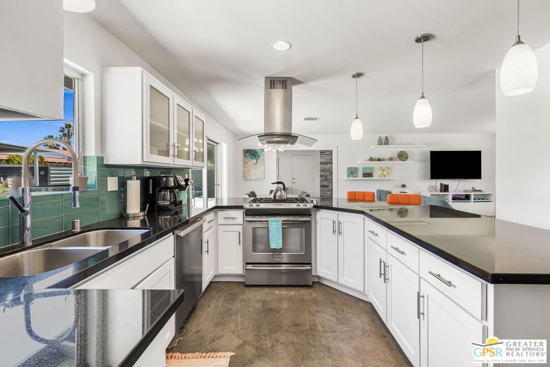 490 East Molino Road Palm Springs, CA 92262 - Photo 24 of 47 a kitchen with stainless steel appliances granite countertop a sink and a stove