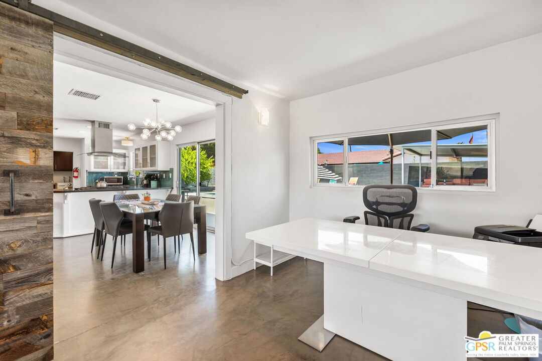 490 East Molino Road Palm Springs, CA 92262 - Photo 27 of 47 a dining hall with stainless steel appliances kitchen island granite countertop a table chairs and a large window
