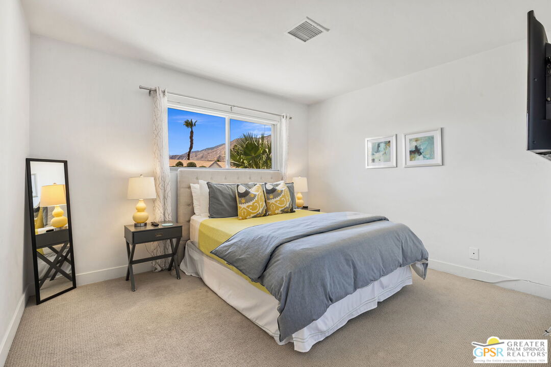 490 East Molino Road Palm Springs, CA 92262 - Photo 31 of 47 a bedroom with a bed and a painting on the wall