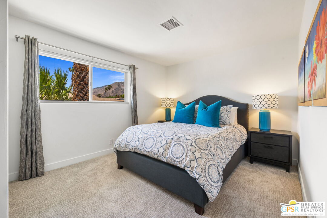 490 East Molino Road Palm Springs, CA 92262 - Photo 33 of 47 a bedroom with a bed and a painting on the wall