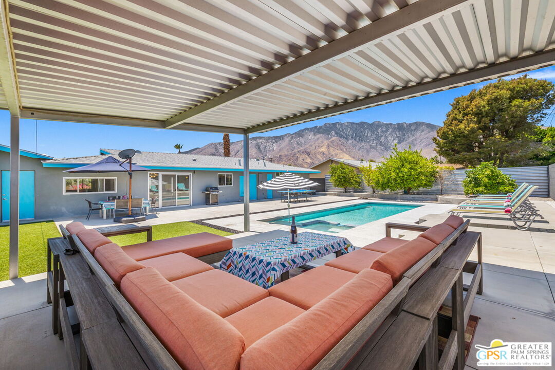 490 East Molino Road Palm Springs, CA 92262 - Photo 7 of 47 a view of a patio with a table and chairs under an umbrella