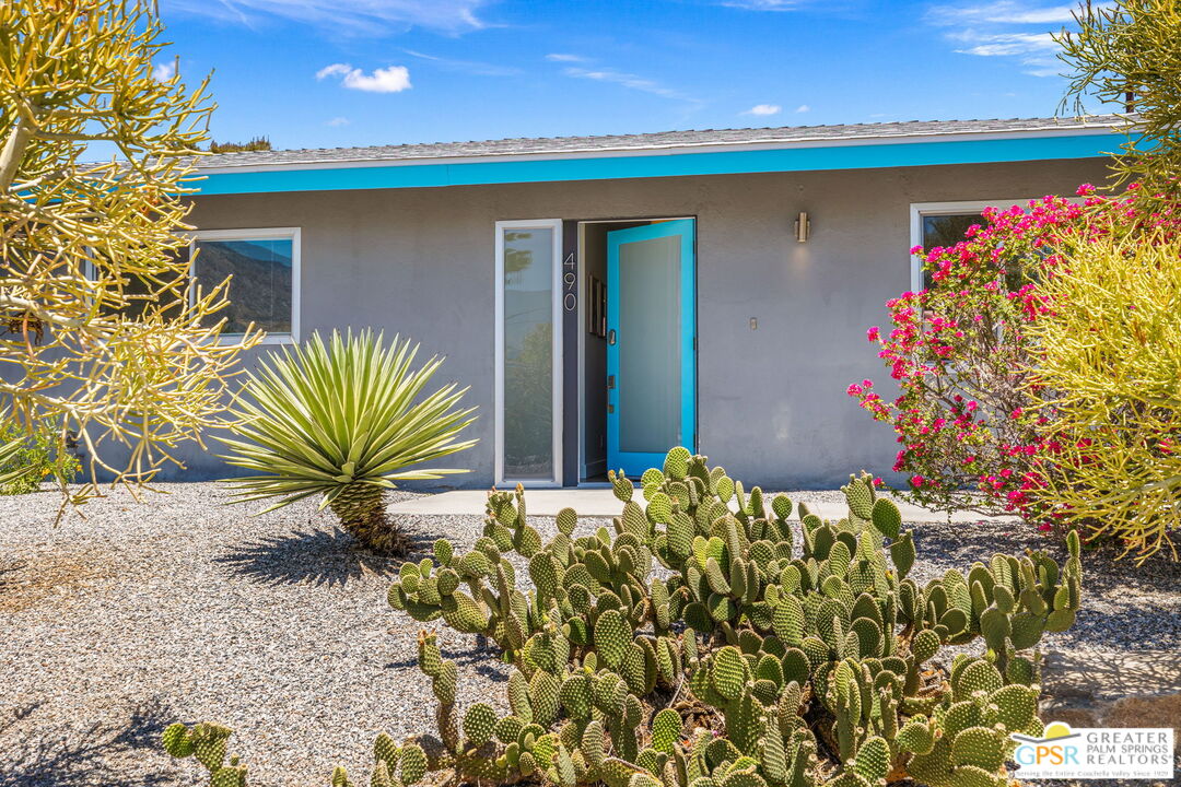 490 East Molino Road Palm Springs, CA 92262 - Photo 10 of 47 a front view of a house with a yard and garage