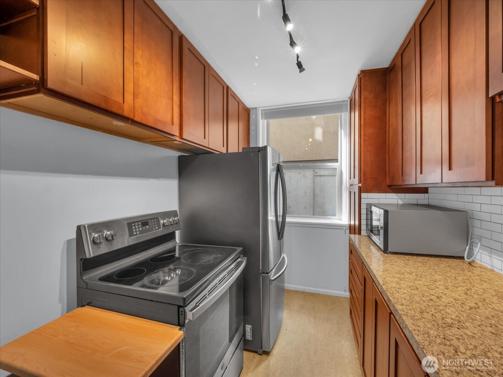 7 Harrison Street, Unit 17 Seattle, WA 98109 - Photo 9 of 20 a kitchen with stainless steel appliances granite countertop a stove a sink and a refrigerator