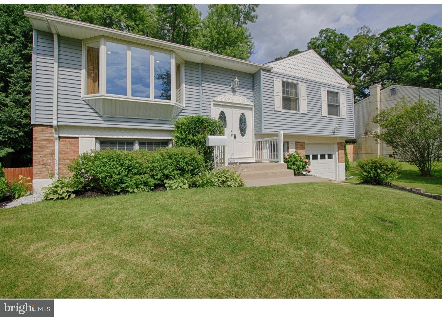 101 Round Hill Road Voorhees, NJ 08043 - Photo 2 of 25 a front view of a house with a garden and plants
