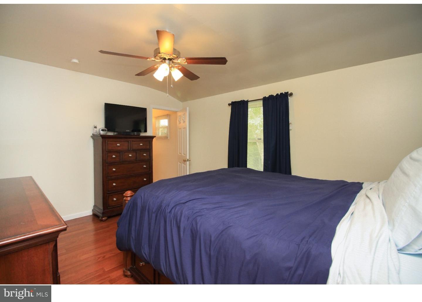 101 Round Hill Road Voorhees, NJ 08043 - Photo 12 of 25 a bedroom with a bed and a flat screen tv