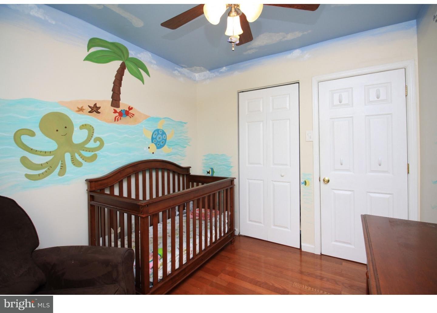 101 Round Hill Road Voorhees, NJ 08043 - Photo 18 of 25 a bedroom with a bed and wooden floor