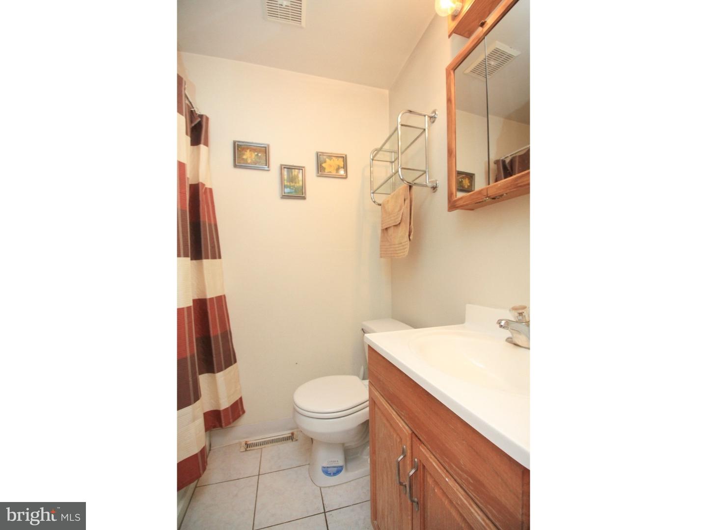 101 Round Hill Road Voorhees, NJ 08043 - Photo 19 of 25 a bathroom with a sink a toilet and shower