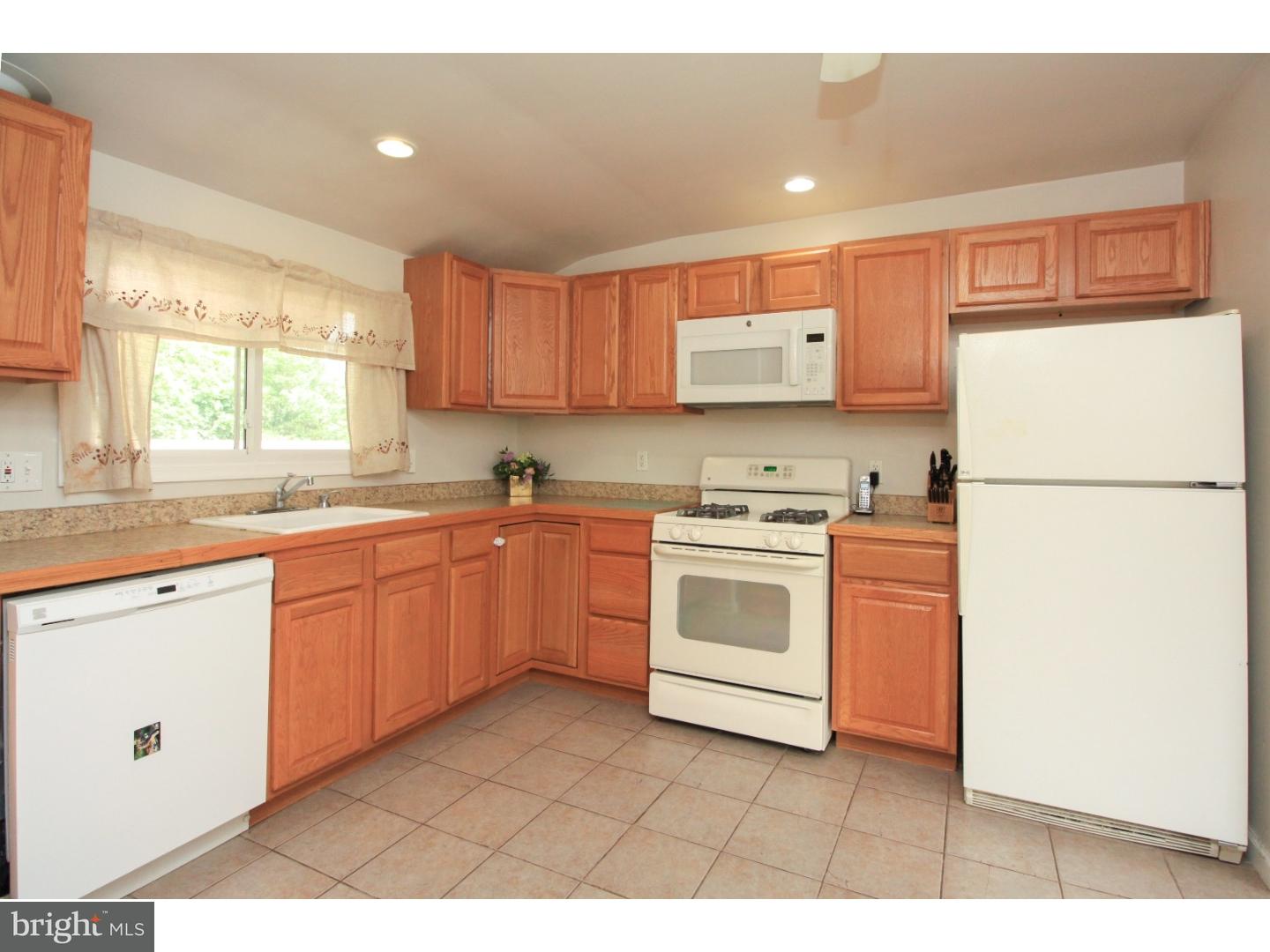 101 Round Hill Road Voorhees, NJ 08043 - Photo 8 of 25 a kitchen with a white stove top oven and refrigerator