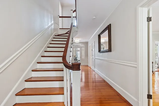 a view of entryway and hall with wooden floor