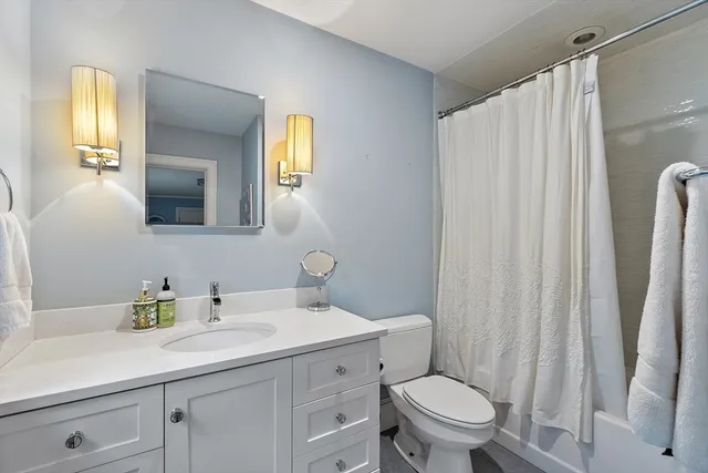 a bathroom with a toilet a sink and a mirror