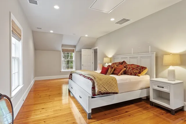 a bedroom with a bed and a large window