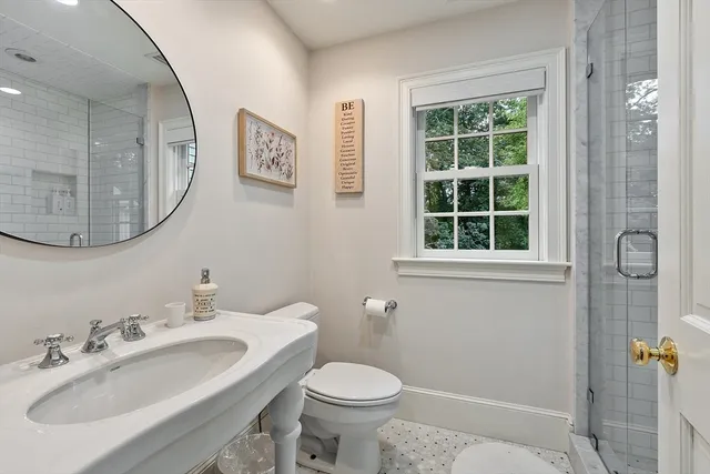 a bathroom with a toilet sink and mirror