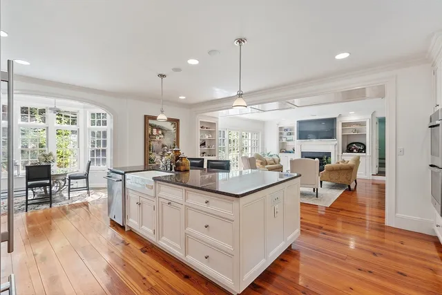 a kitchen with counter top space and wooden floor