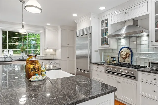 a kitchen with stove and cabinets