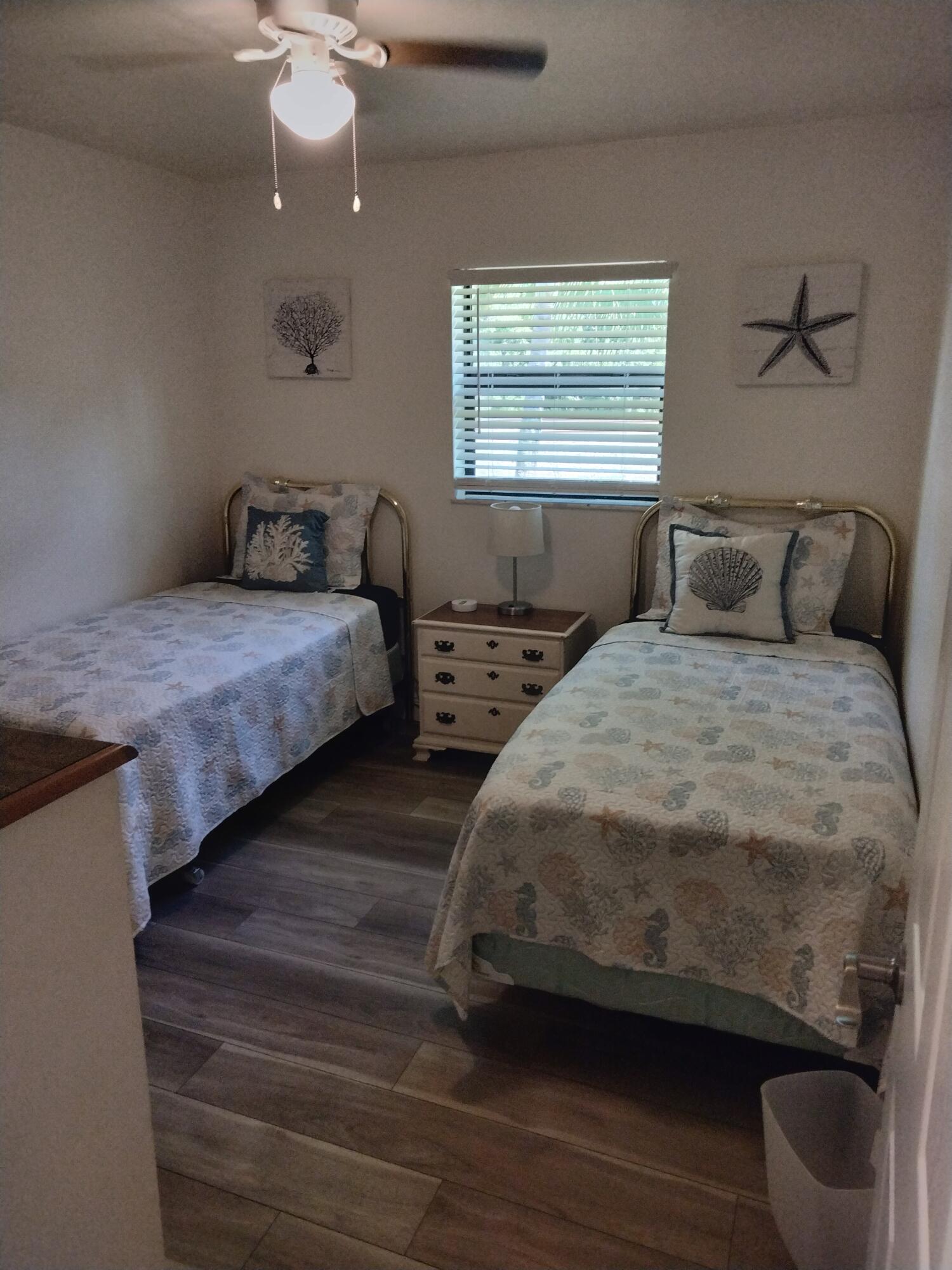 1150 Northeast County Line Road Jensen Beach, FL 34957 - Photo 12 of 17 a bedroom with double bed and a window